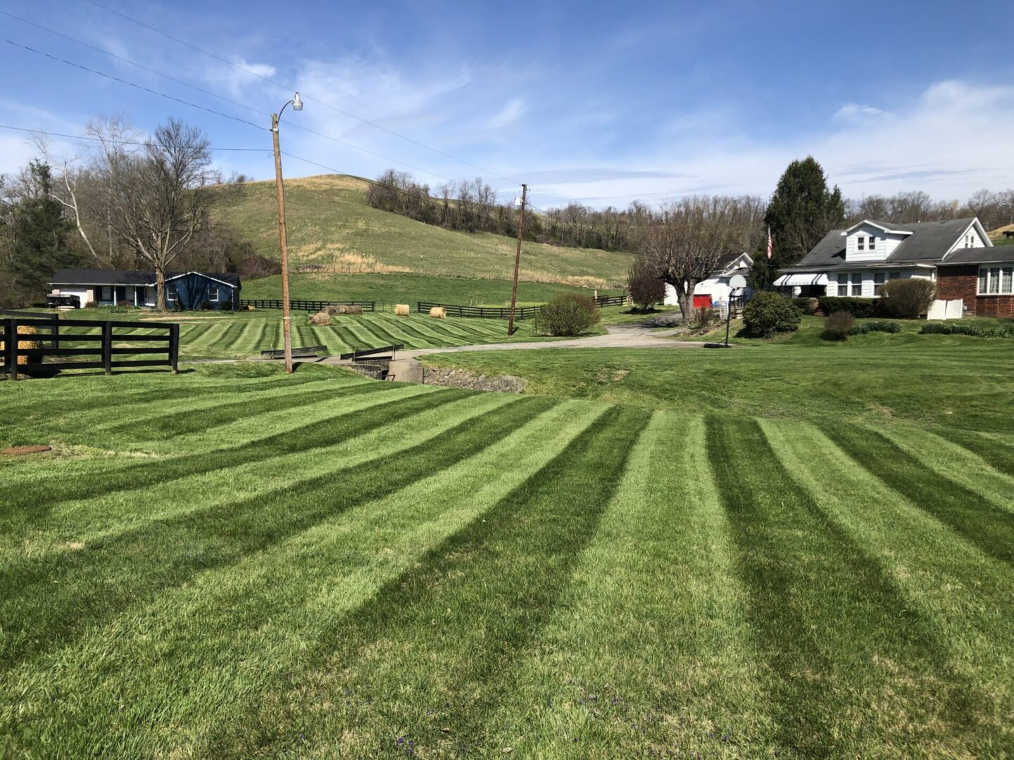 A field with many rows of grass in the middle.